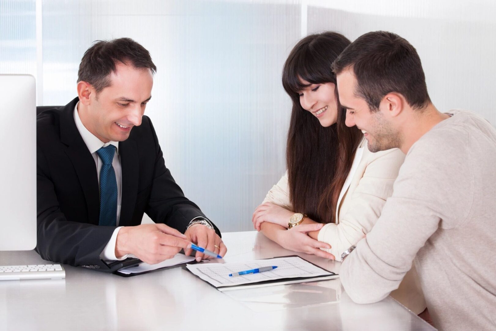 A man and two women sitting at a table.